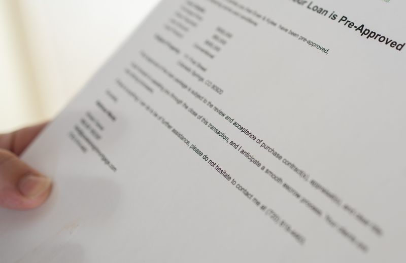 Close-up of a pre-approval letter on a clipboard with the headline Your Loan is Pre-Approved